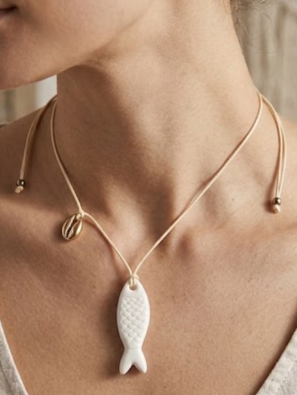 Fish on a white cord necklace